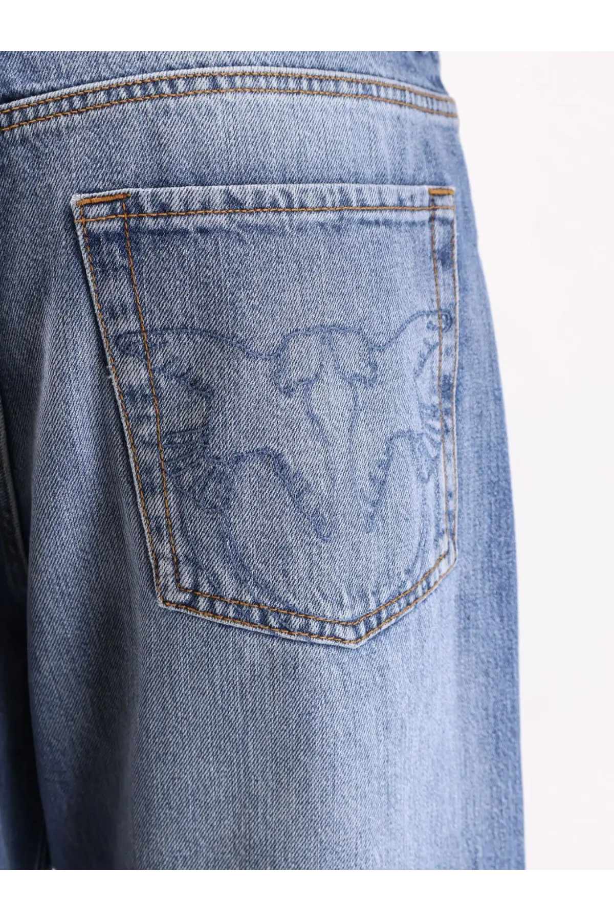 Back side of pinko women’s wanda wide leg light-wash denim jeans with subtle embroidered eagle on the pocket