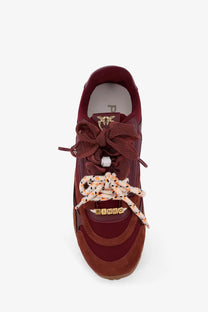 Pinko women’s yulia suede sneaker in maroon with mesh panels patterned laces and gold-tone logo detail