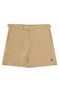 Beige Polo Ralph Lauren men’s costume Monaco shorts with button, belt loops, and blue polo player logo on lower left leg