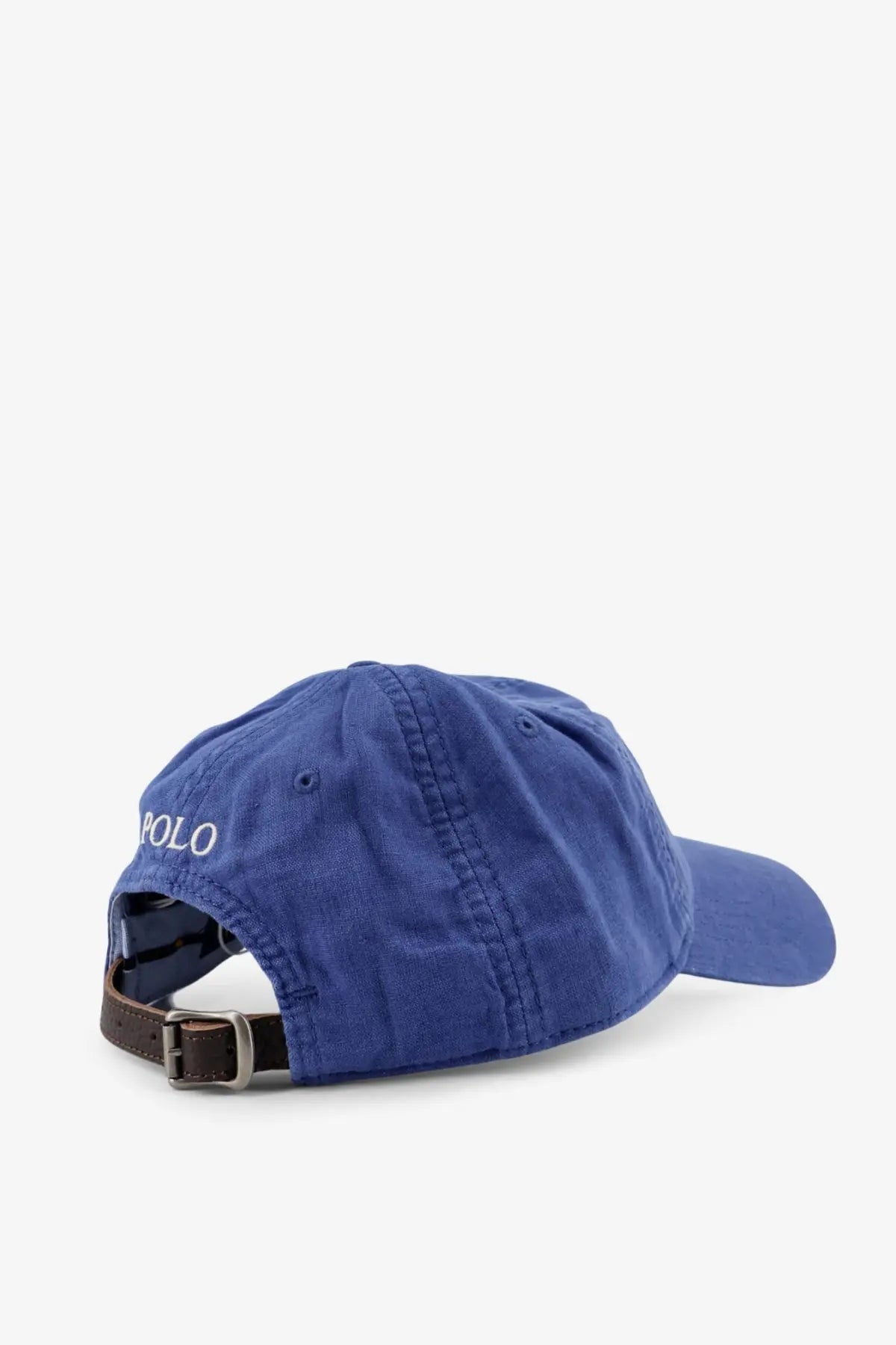 Royal blue cotton baseball cap with white embroidered polo branding and brown leather adjustable strap shown from the back