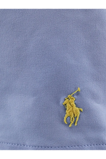 A yellow embroidered polo player logo on a light blue cotton shirt paired with polo ralph lauren men’s blue nylon swim trunks