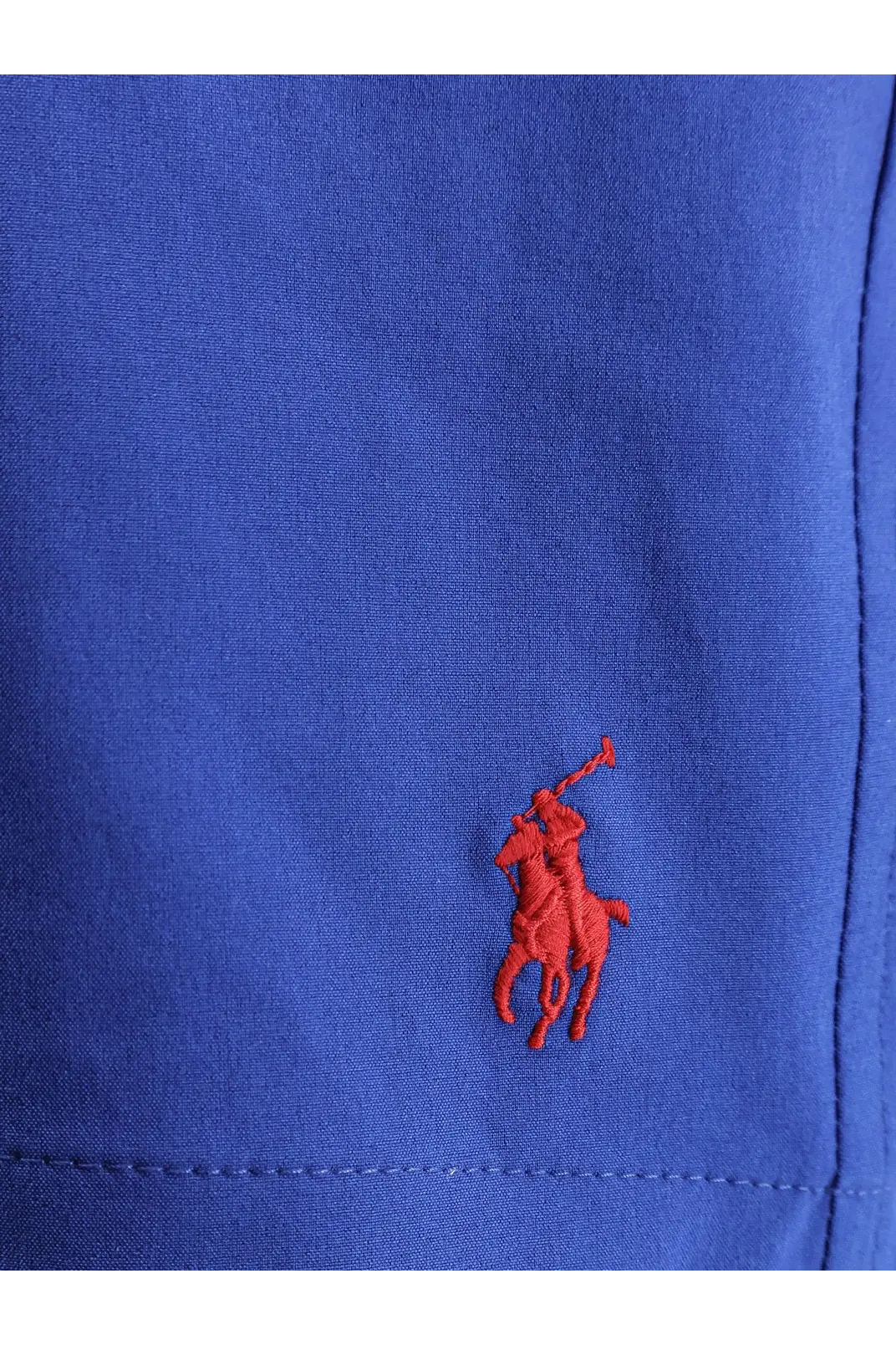 A vibrant royal blue polo shirt with a classic red embroidered Ralph Lauren logo for men
