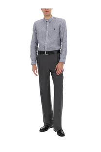 A man wearing a Polo Ralph Lauren men’s blue and white striped button-down shirt with embroidered polo logo