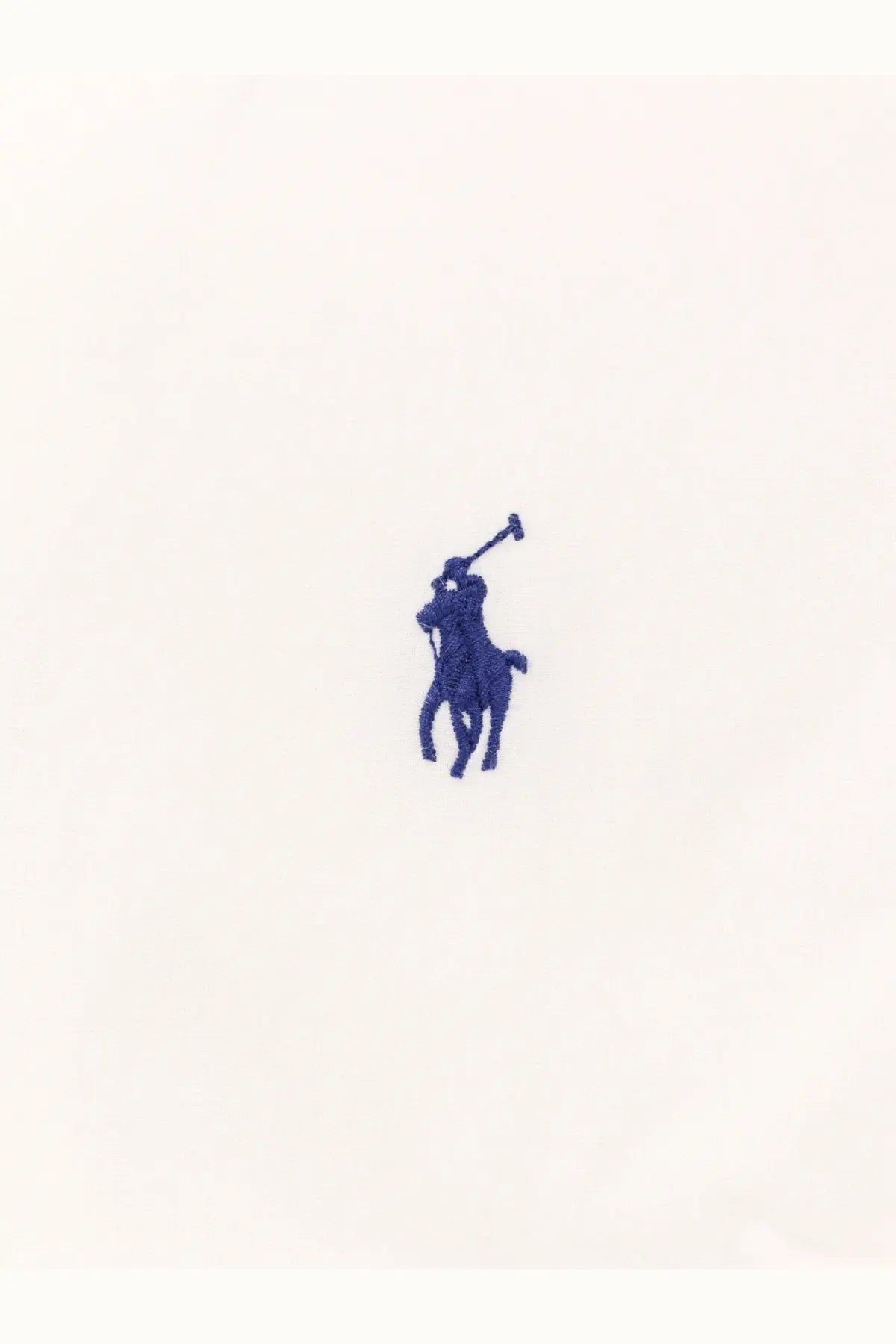 Blue embroidered polo player logo on white stretch cotton fabric of polo ralph lauren men’s shirt front side
