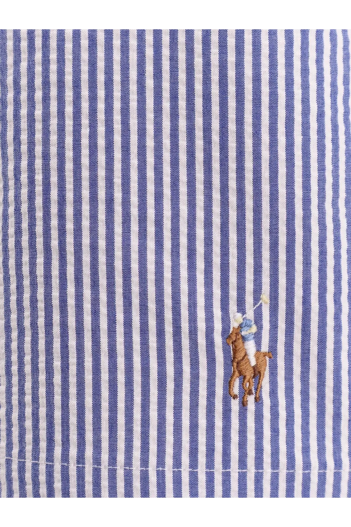 Blue and white striped cotton shirt with embroidered polo player logo shown with Polo Ralph Lauren men’s swim trunks blue