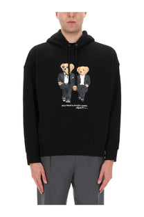 Black hooded sweatshirt featuring a printed graphic of two teddy bears in tuxedos by Polo Ralph Lauren