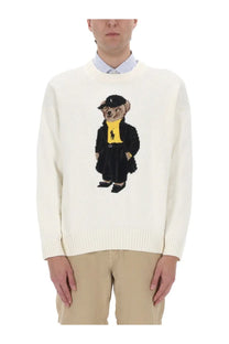 Cream-colored knit unisex Polo Ralph Lauren sweater featuring embroidered bear in black suit and yellow shirt