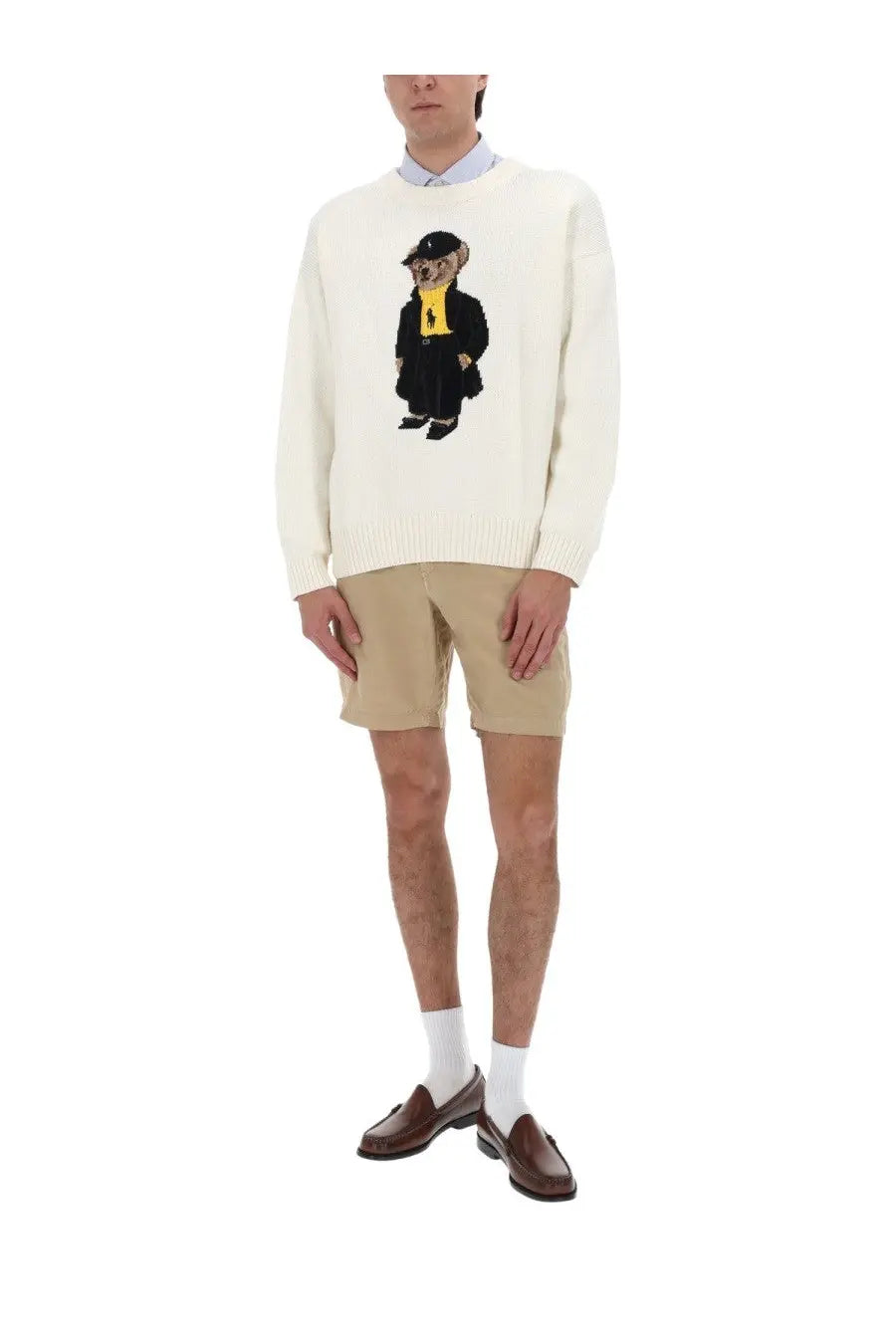 Cream-colored knit sweater with detailed embroidered bear in formal suit yellow scarf and black hat by Polo Ralph Lauren