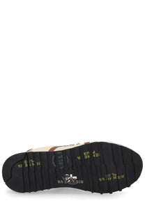 Black rubber sole with yellow rien ne va branding and logo on the back side of premiata mens sneaker lucy white