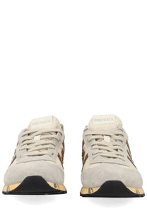 Premiata men’s sneaker lucy white cream suede with brown accents and black and gold sole featuring premiata brand name on tongue