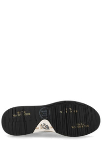Black rubber sole with textured tread and gold lettering and white triangular logo patch on premiata men’s sneaker mick beige