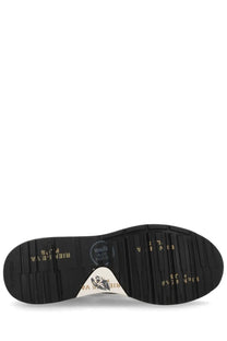 Black rubber sole with gold lettering and white triangular logo patch of premiata men’s sneaker mick black back side