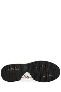 Black rubber sole with gold lettering and white triangular logo patch on premia ta men’s sneaker mick blue back view