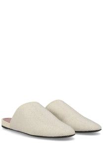 Premiata women’s cream-colored leather slip-on mules with subtle woven texture and black rubber soles