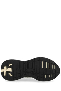 Black rubber sole with beige puma logo and branding on premiata women’s sneaker lauryn white back side