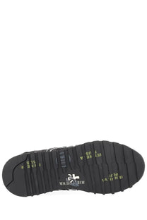 Black rubber sole with textured tread and yellow branding on premiata women’s sneaker lucy black