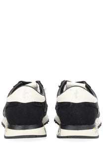 Premiata women’s sneaker lucy black showing back side with black and white distressed textured upper and subtle heel branding
