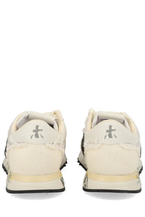 Premiata women’s sneaker lucy white cream-colored distressed canvas with black rubber sole and gray logo on the heel back side