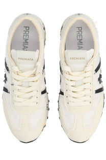 Cream-colored Premiata women’s sneaker Lucy White with black accents and distressed vintage-inspired leather design