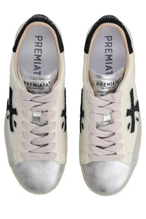 Premiata women’s sneaker Stevend white cream color with silver metallic toe caps and black embroidered crosses on sides