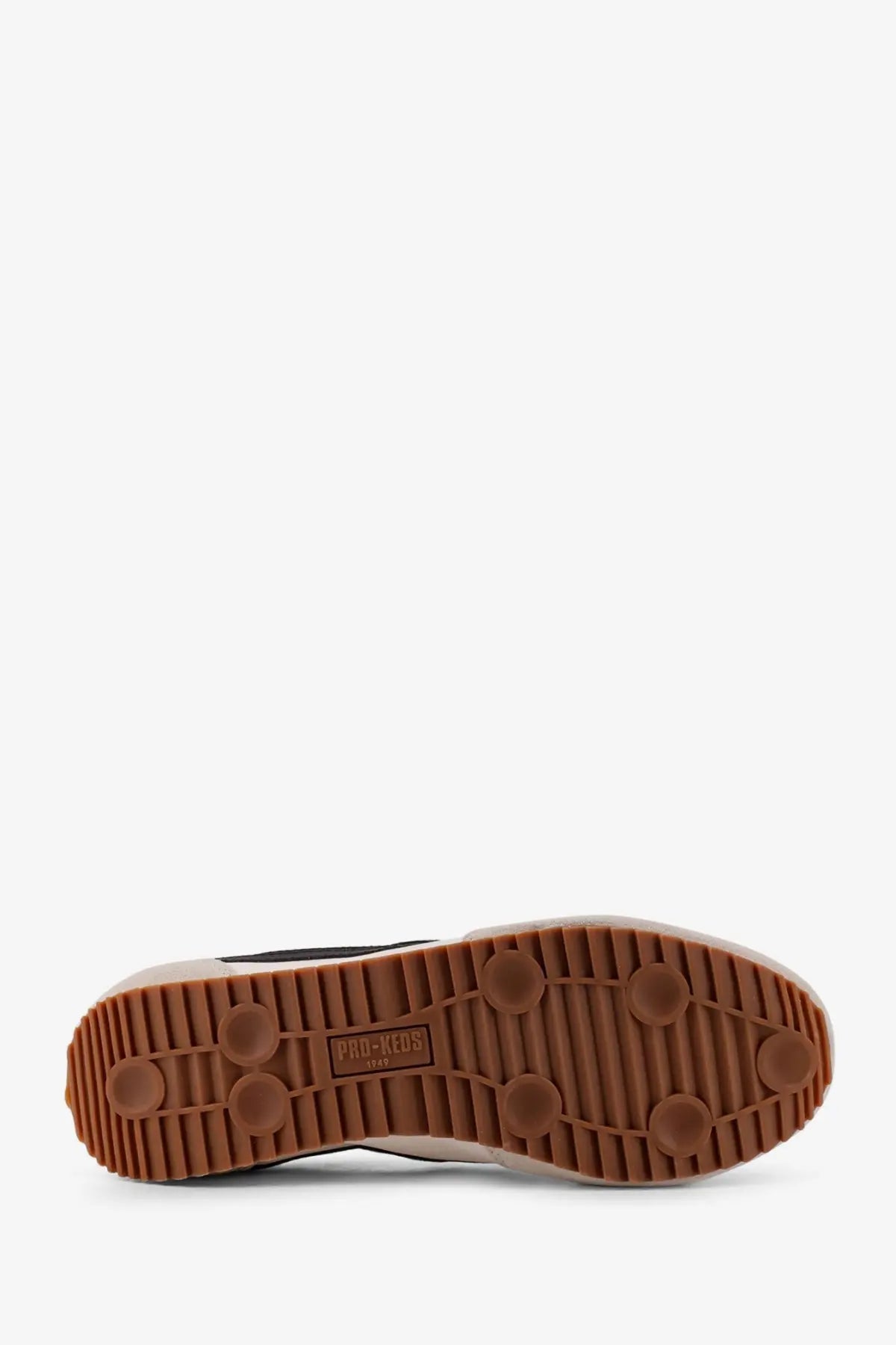 Brown rubber sole with circular tread patterns and pro-keeds 1947 label on pro-keds men’s racer leather sneakers white