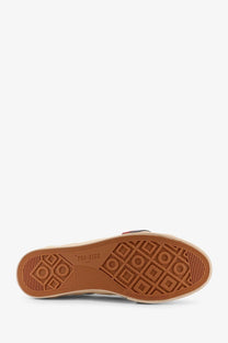 Tan rubber sole with geometric tread pattern and pro-kids 1945 branding on pro-keds men’s royal classic leather sneakers white
