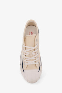 Pro-Keds men’s royal intrepid beige canvas low-top sneaker with navy blue piping and white rubber sole