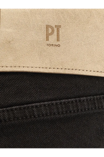 Beige suede patch with embossed pt torino logo stitched on the back of men’s black denim jeans black
