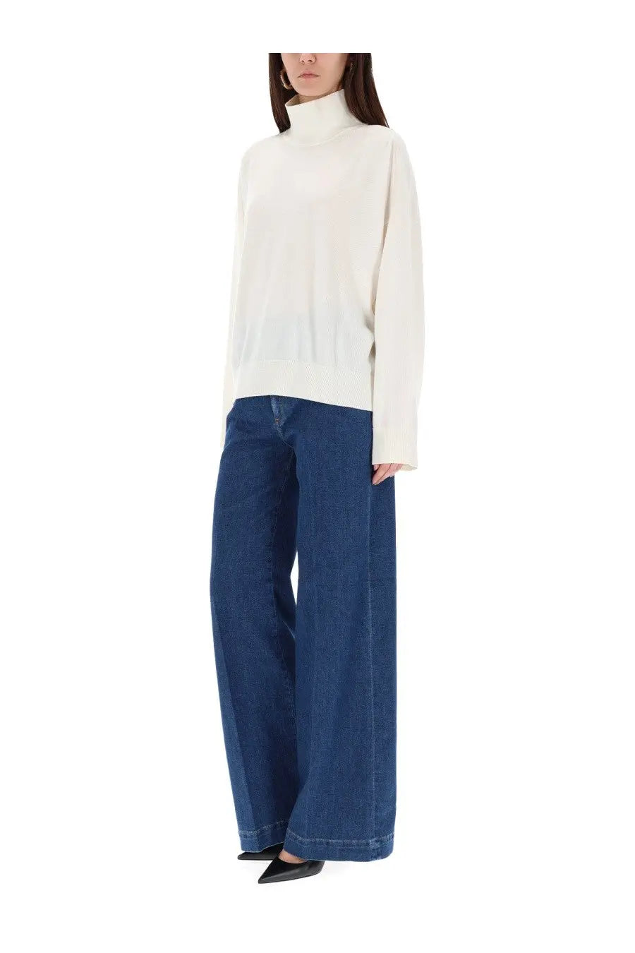 Cream-colored oversized turtleneck sweater with soft knit texture paired with pt torino womens poppy blue jeans