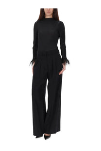 Black high-neck knit top with feathered cuffs paired with pt torino women’s pants frankie black wide-leg trousers