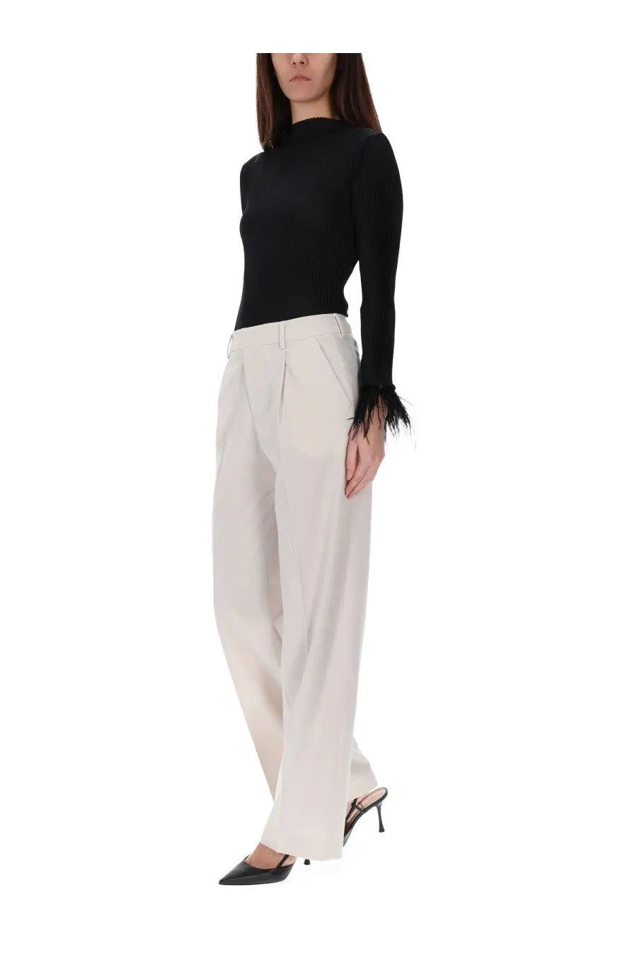 Black long-sleeved knit top with feathered cuffs paired with pt torino women’s pink pants lola model