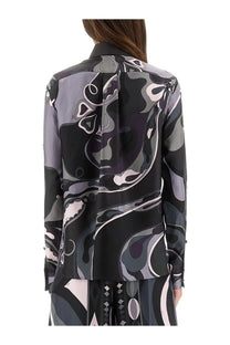 A woman wears a pucci women’s orchid print long-sleeved silk blouse in black gray and soft pink abstract pattern