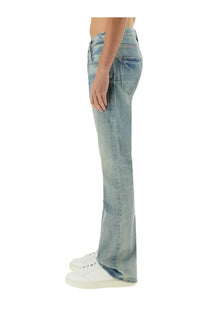 Light-wash coated denim flare jeans for men by Purple Brand with distressed details in blue color