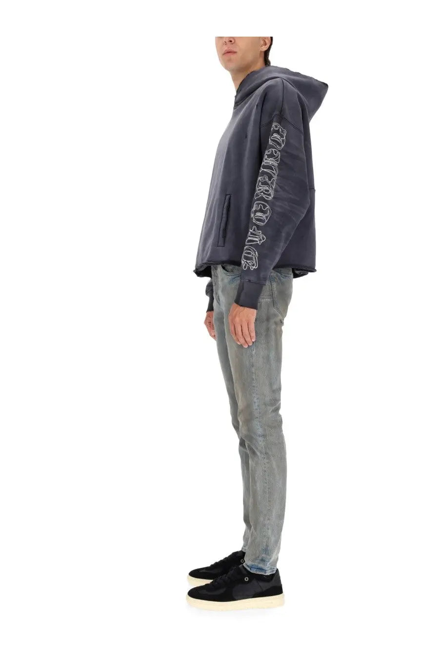 Dark gray hoodie with white embroidered lettering on the left sleeve paired with purple brand men’s monterrico mud blue pants