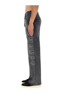 Dark gray denim purple brand men’s pants featuring a vertical rhinestone embellished chrome hearts logo down the leg