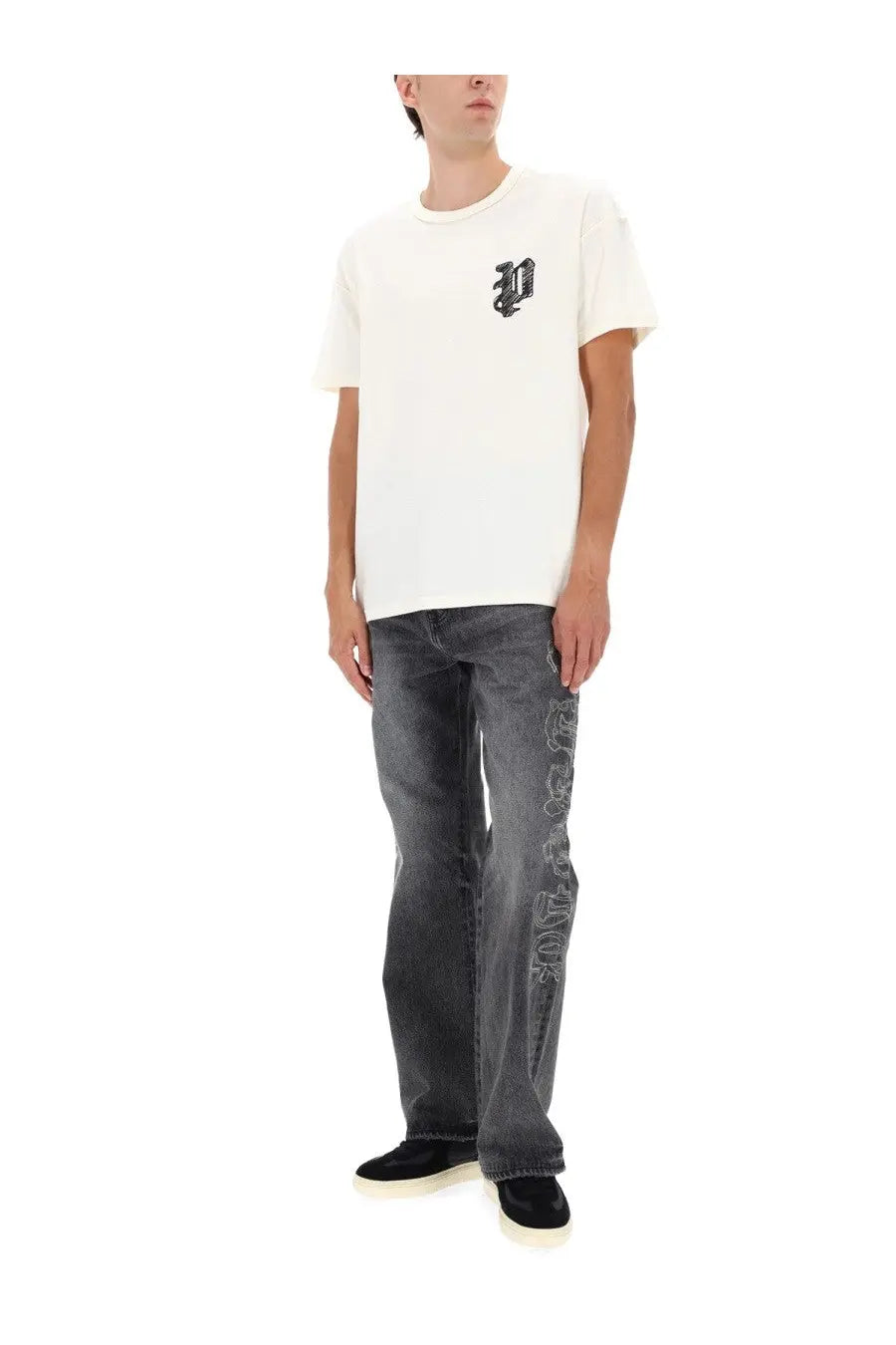 White short-sleeved t-shirt with black embroidered logo on left chest paired with purple brand mens black traced gothic pants