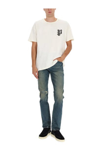 Off-white short-sleeved t-shirt with small black embroidered logo paired with purple brand men’s slim fit blue jeans