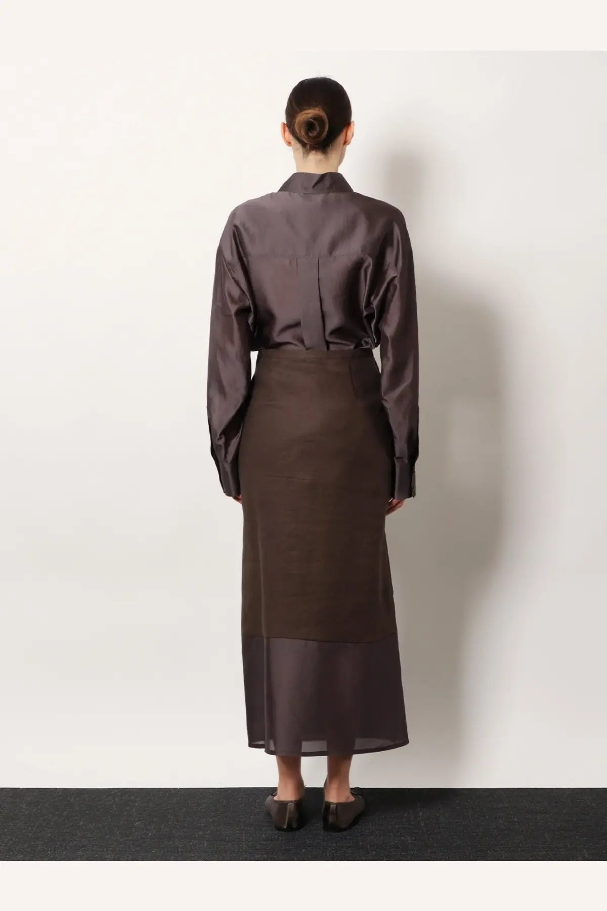 A sleek dark brown satin blouse with a structured collar and long sleeves paired with r2w women’s amora linen skirt brown