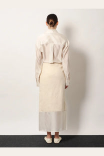 Back view of r2w women’s amora linen off-white blouse with structured back and long sleeves paired with matching skirt