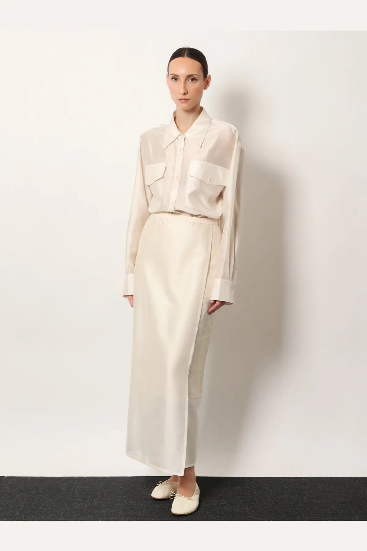 R2w women’s amora linen skirt white paired with an off-white minimalist satin blouse with long sleeves and front patch pockets