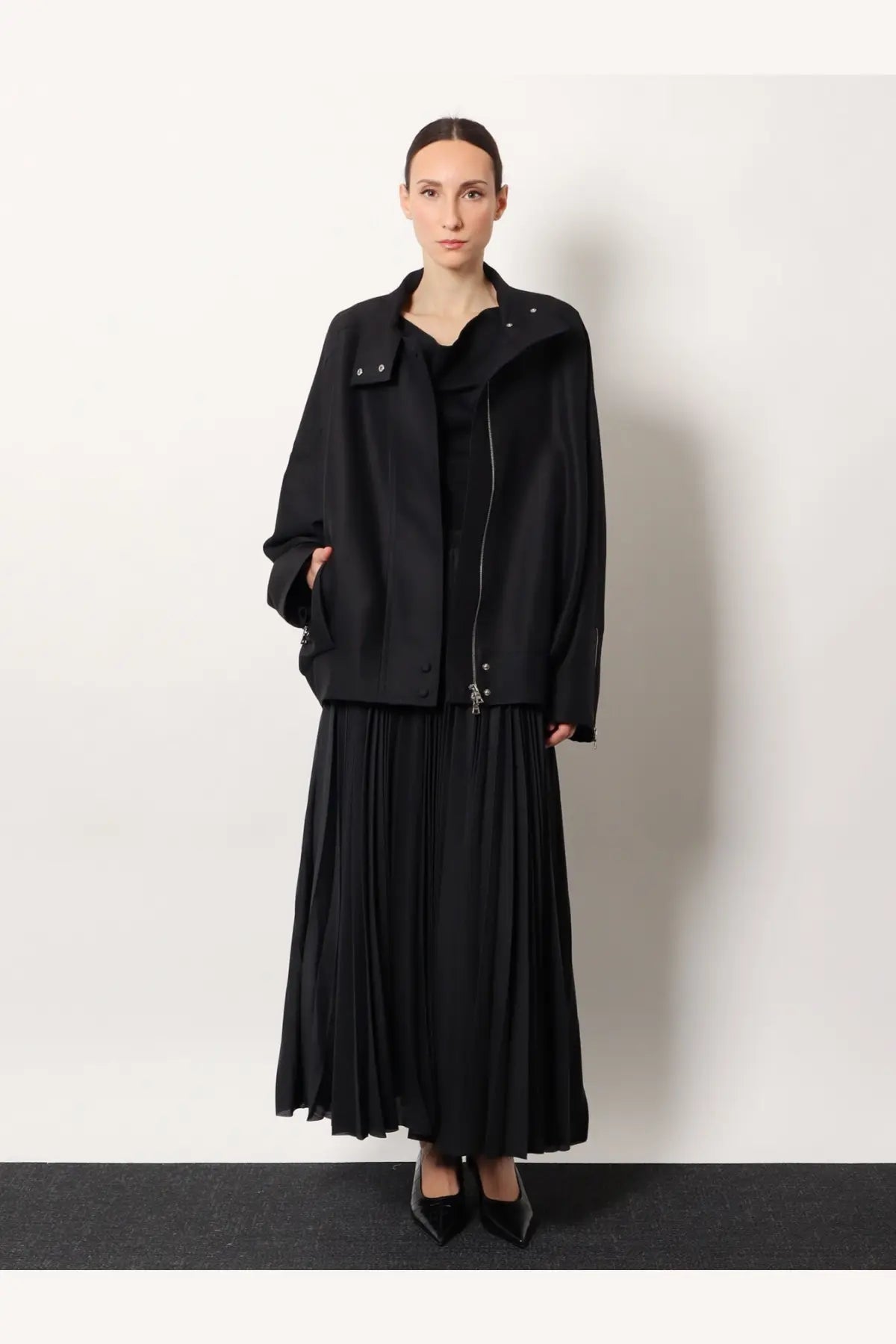 R2w women’s julio black wool and silk jacket paired with a black pleated midi skirt with vertical folds
