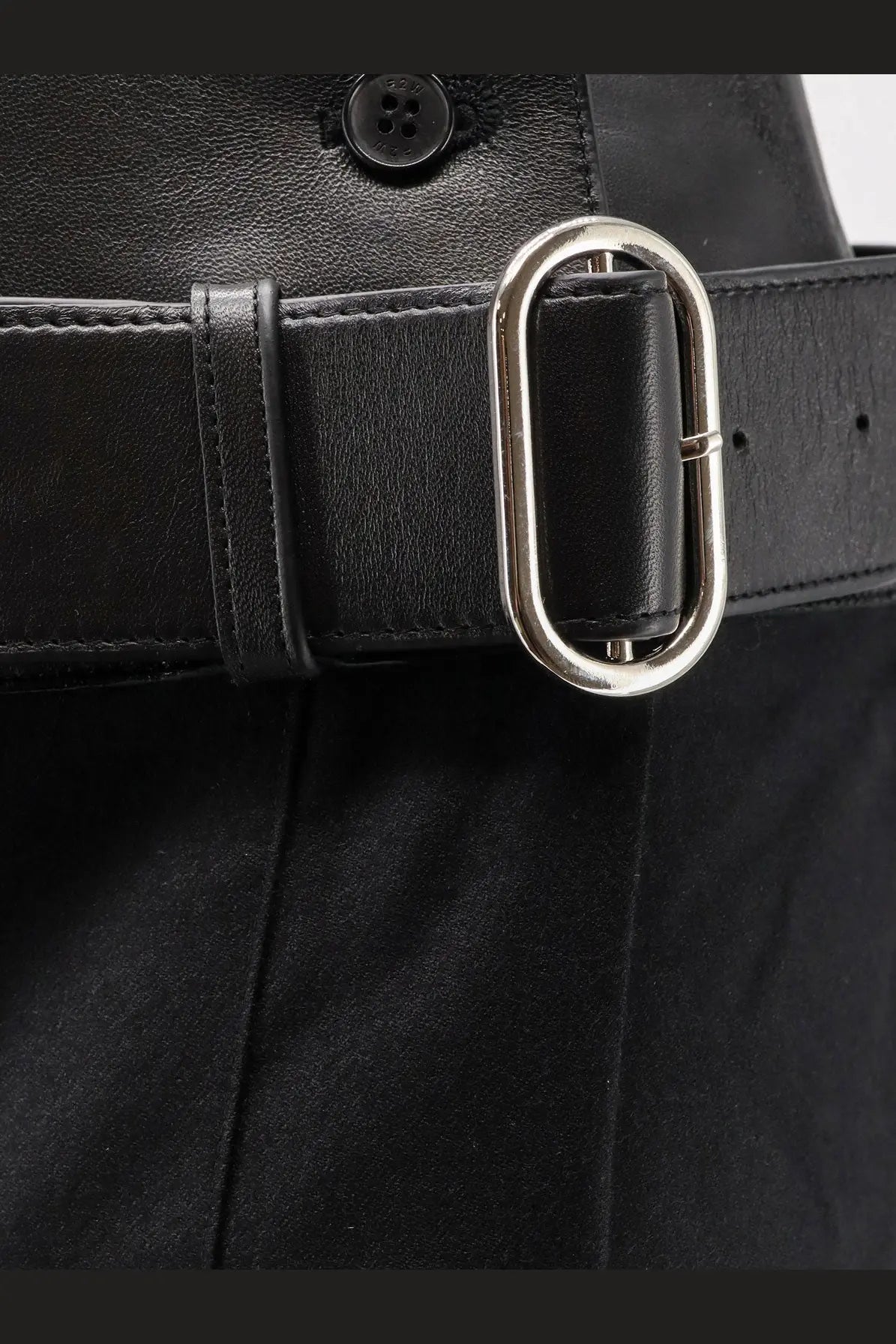 Black leather belt with a sleek silver toned oval buckle paired with r2w womens nayla pleated wool trousers skirt black