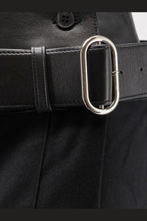 Black leather belt with a sleek silver toned oval buckle paired with r2w womens nayla pleated wool trousers skirt black