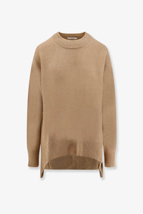 A soft camel-colored oversized knit sweater with ribbed crew neckline and cuffs in wool and cashmere