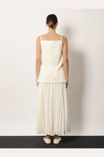 R2W women’s tinta square neck top white minimalist off-white sleeveless top with thin straps and flared hem paired with pleated skirt