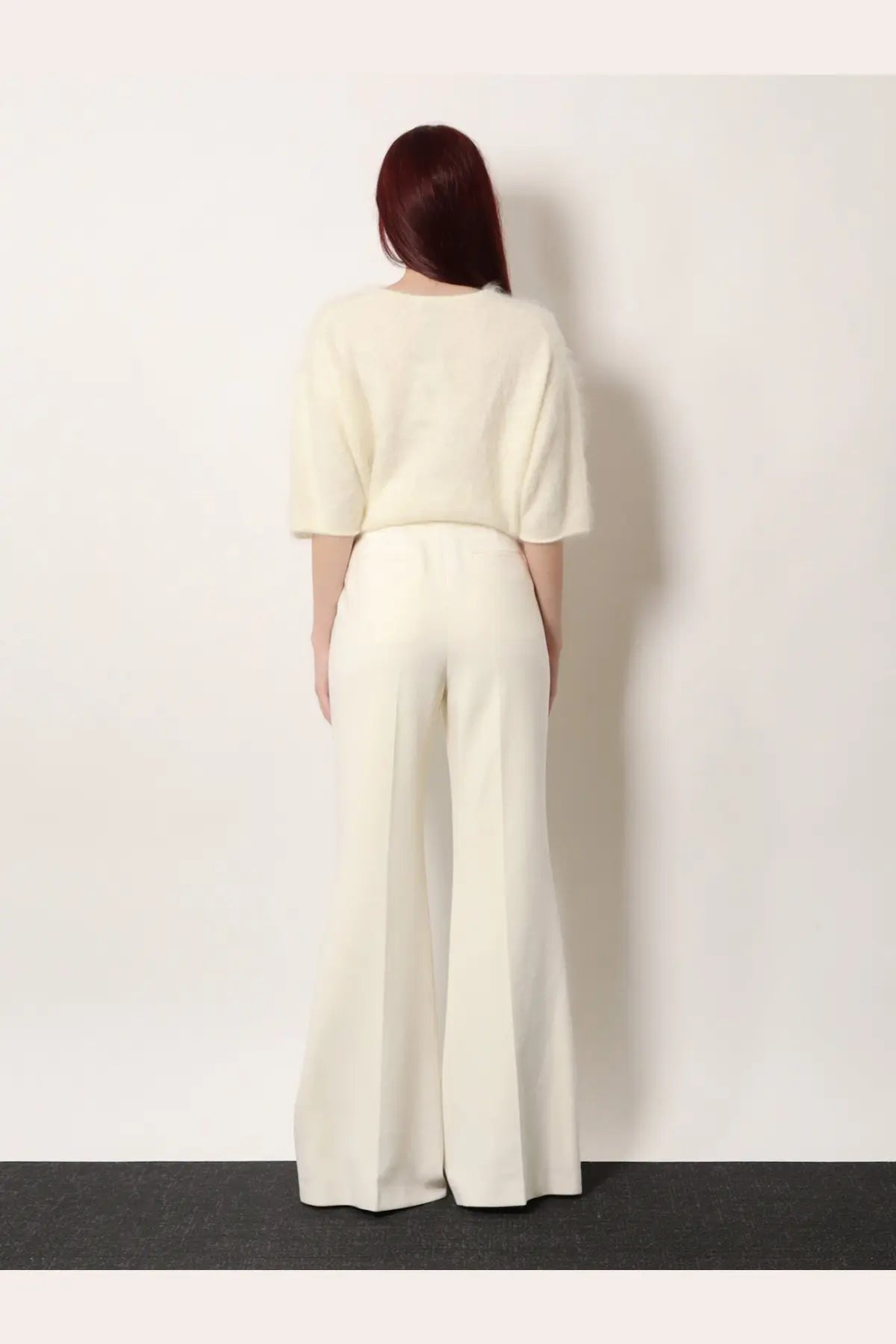 Cream-colored soft knit top with three-quarter sleeves paired with high-waisted wide-leg vonnie wool trousers white