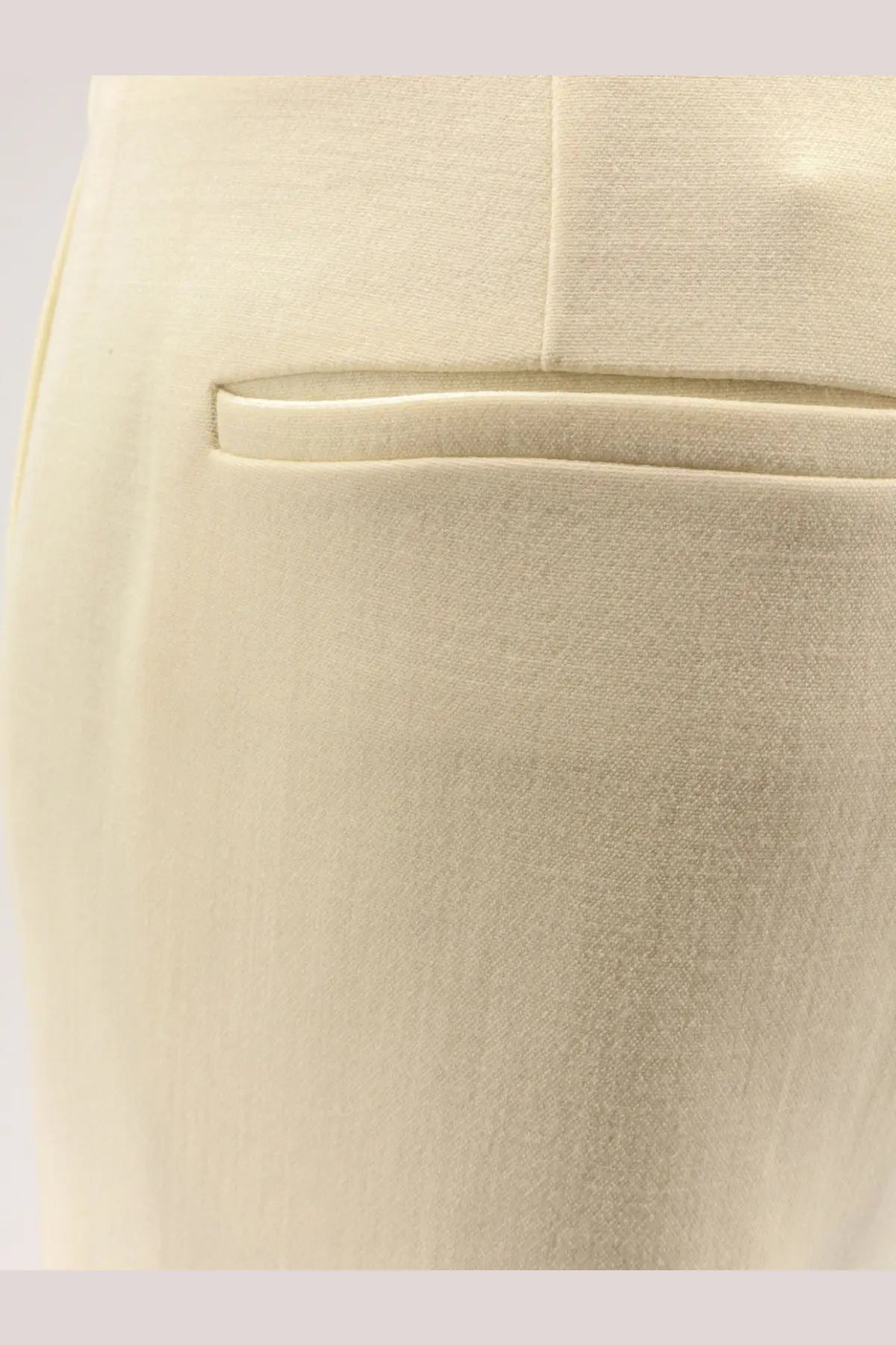 Cream-colored tailored wool trousers with subtle woven texture and structured front pocket from r2w women’s vonnie colecction