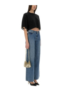 Gold chain-link mini bag with textured woven pattern and structured shape paired with rabanne women’s black knit crop shirt