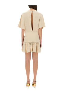 Beige short-sleeved mini dress by rabanne with back slit and ruffled hem shown from the back side