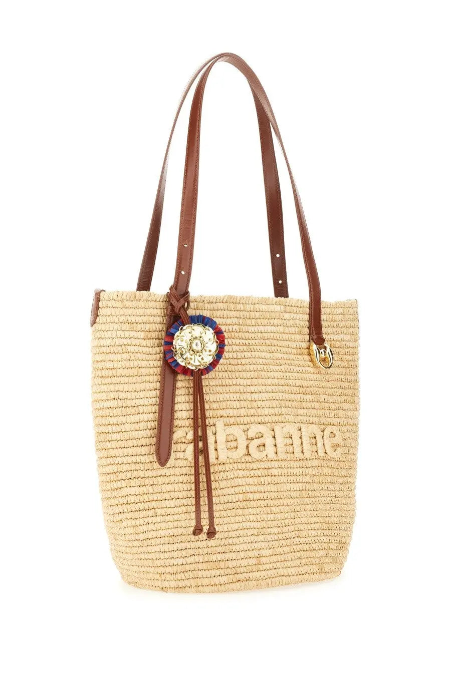Beige straw tote bag with brown leather handles and a decorative ribbon badge by Rabanne womens tote bag